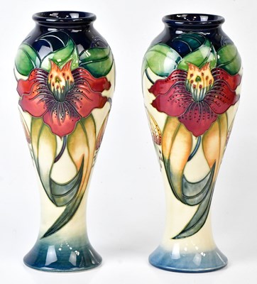 Lot 263 - MOORCROFT; a pair of 'Anna Lily' pattern vases...