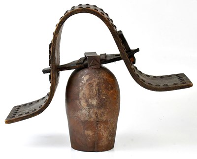 Lot 521 - A vintage Continental cow bell on a wooden...