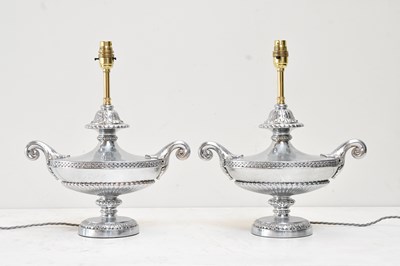 Lot 106 - A pair of contemporary silvered metal twin...