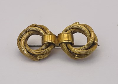 Lot 647 - A yellow metal woven double hooped brooch,...