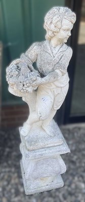 Lot 896 - A reconstituted concrete boy with a basket,...