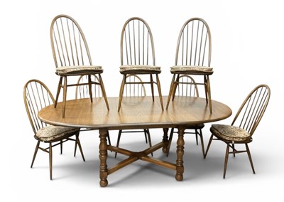 Lot 36 - ERCOL; a modern medium elm extending oval...