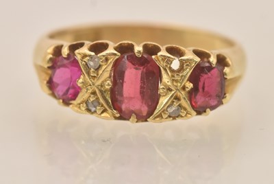 Lot 1223 - A yellow metal ruby and diamond set three...
