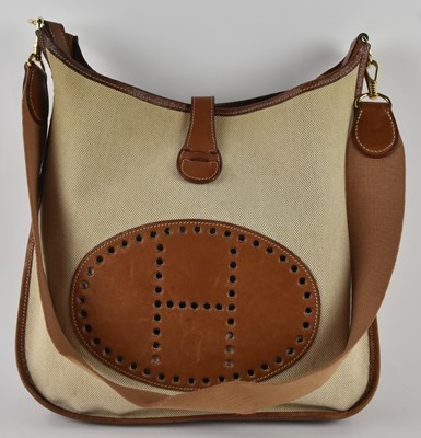 Lot 452 - HERMÈS; a cream canvas and tan leather...