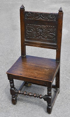Lot 1666 - An 18th century carved oak hall chair, 95cm.