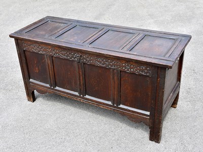 Lot 1668 - An oak coffer with hinged lid above a four...