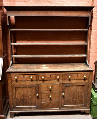 Lot 1655 - A George III oak dresser, with open plate rack,...