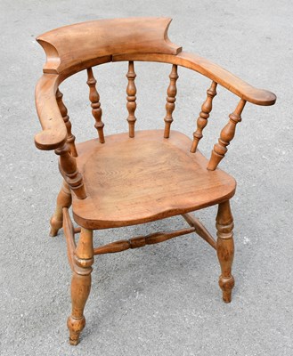 Lot 1594 - An elm seated smoker's bow back elbow chair on...