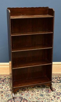 Lot 1693 - An early 20th century oak open bookcase with...