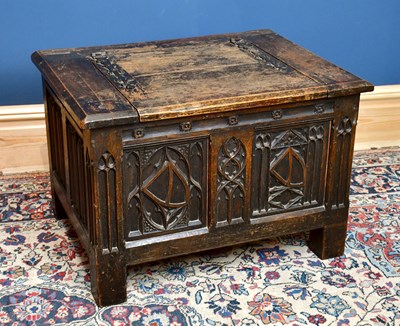 Lot 1565 - A 1920s Gothic Revival carved oak settle, with...