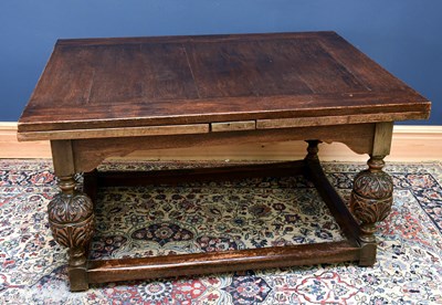 Lot 1699 - A mid 20th century large oak draw-leaf table,...