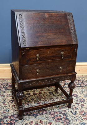 Lot 1679 - A mid 20th century small oak bureau, with two...