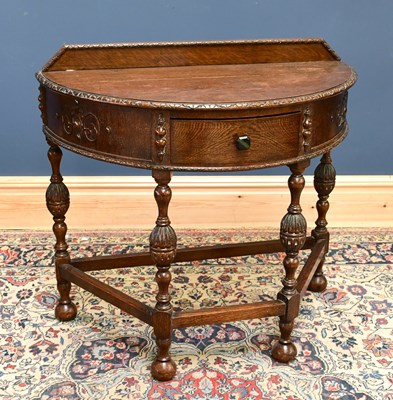 Lot 1673 - An early 20th century oak hall table, with...
