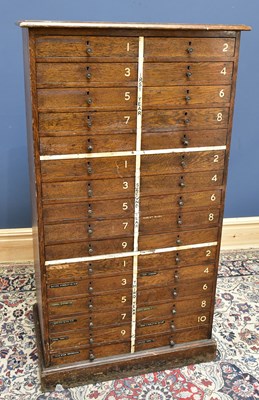 Lot 1574 - An early 20th century oak school cabinet, with...