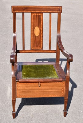 Lot 1705 - An oak framed wing back armchair upholstered...