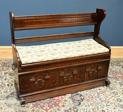 Lot 1660 - A small oak settle with side carrying handles...