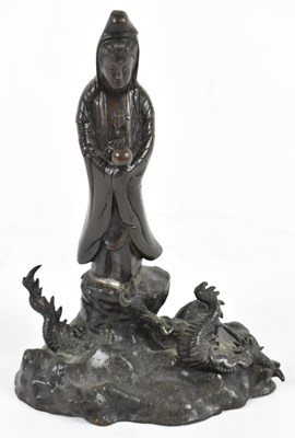 Lot 511 - A Chinese patinated metal figure of Guanyin...
