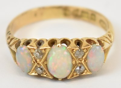 Lot 632 - An 18ct yellow gold opal and diamond ring,...