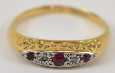 Lot 630 - A yellow metal and platinum three stone ruby...