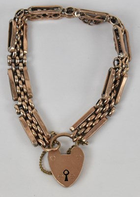 Lot 610 - A 9ct rose gold bracelet with padlock clasp,...