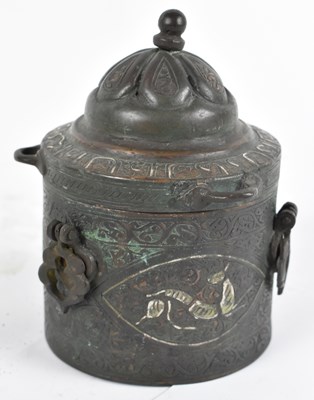 Lot 487 - An Islamic copper and silver inlaid circular...
