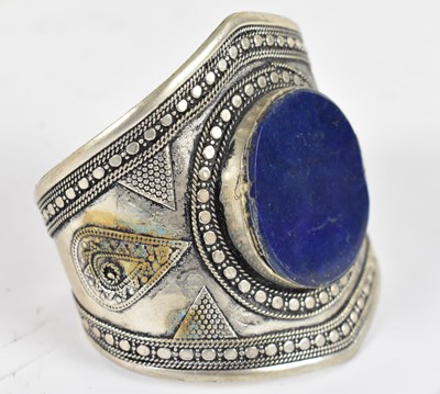 Lot 663 - A late 19th century Eastern white metal bangle...