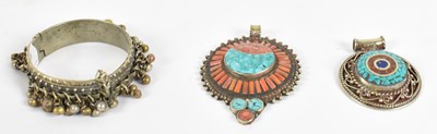 Lot 665 - Two Eastern white metal pendants set with semi-...