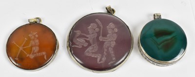 Lot 666 - Three Eastern white metal framed pendants, two...