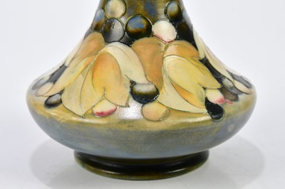 Lot 86 - WALTER MOORCROFT; a baluster vase with...