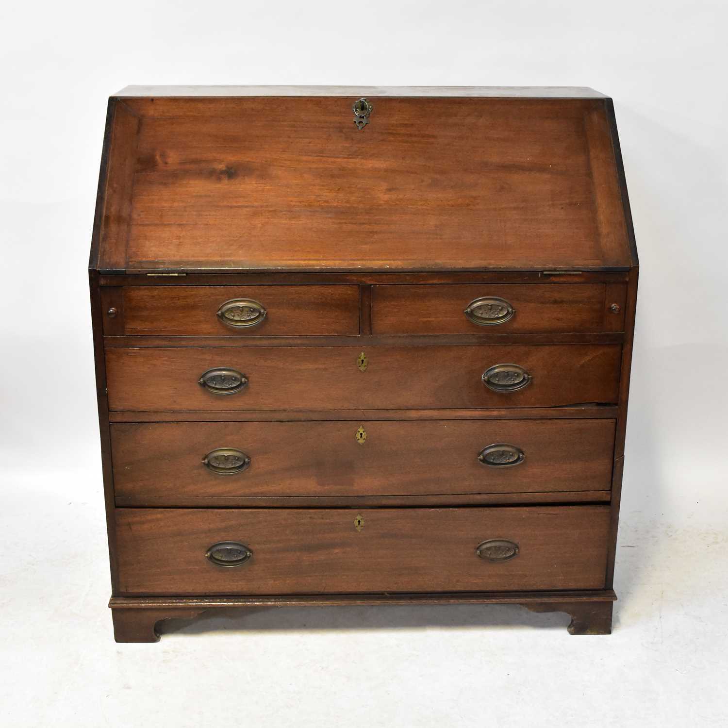 Lot 34 - A 19th century mahogany bureau, the fall front...