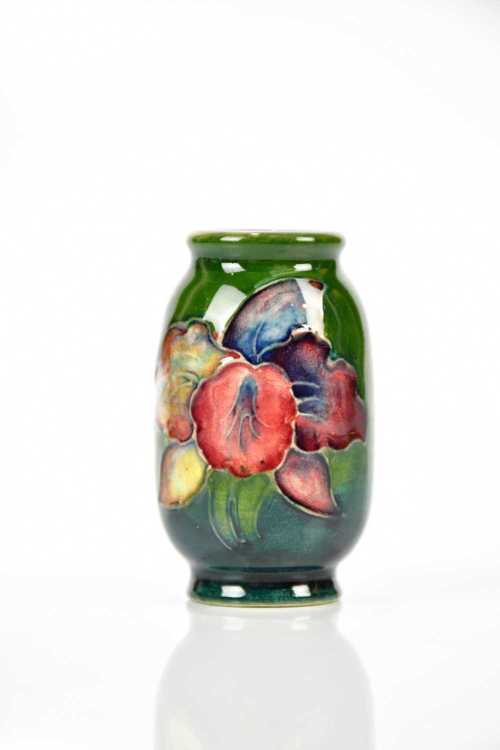 Lot 1283 - WALTER MOORCROFT; a miniature vase in the...
