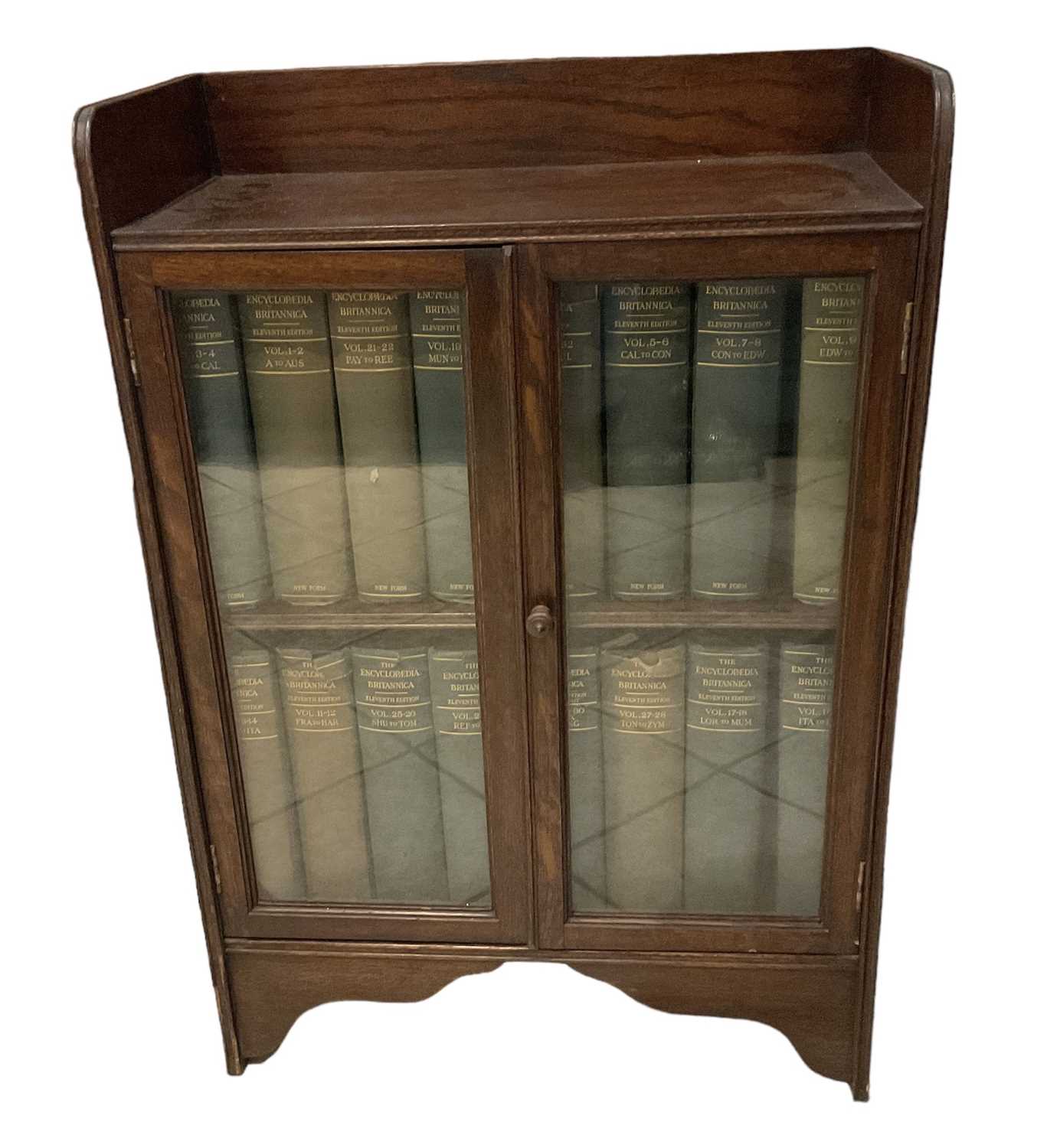 Lot 34 - A 1920s oak display cabinet with pair of...