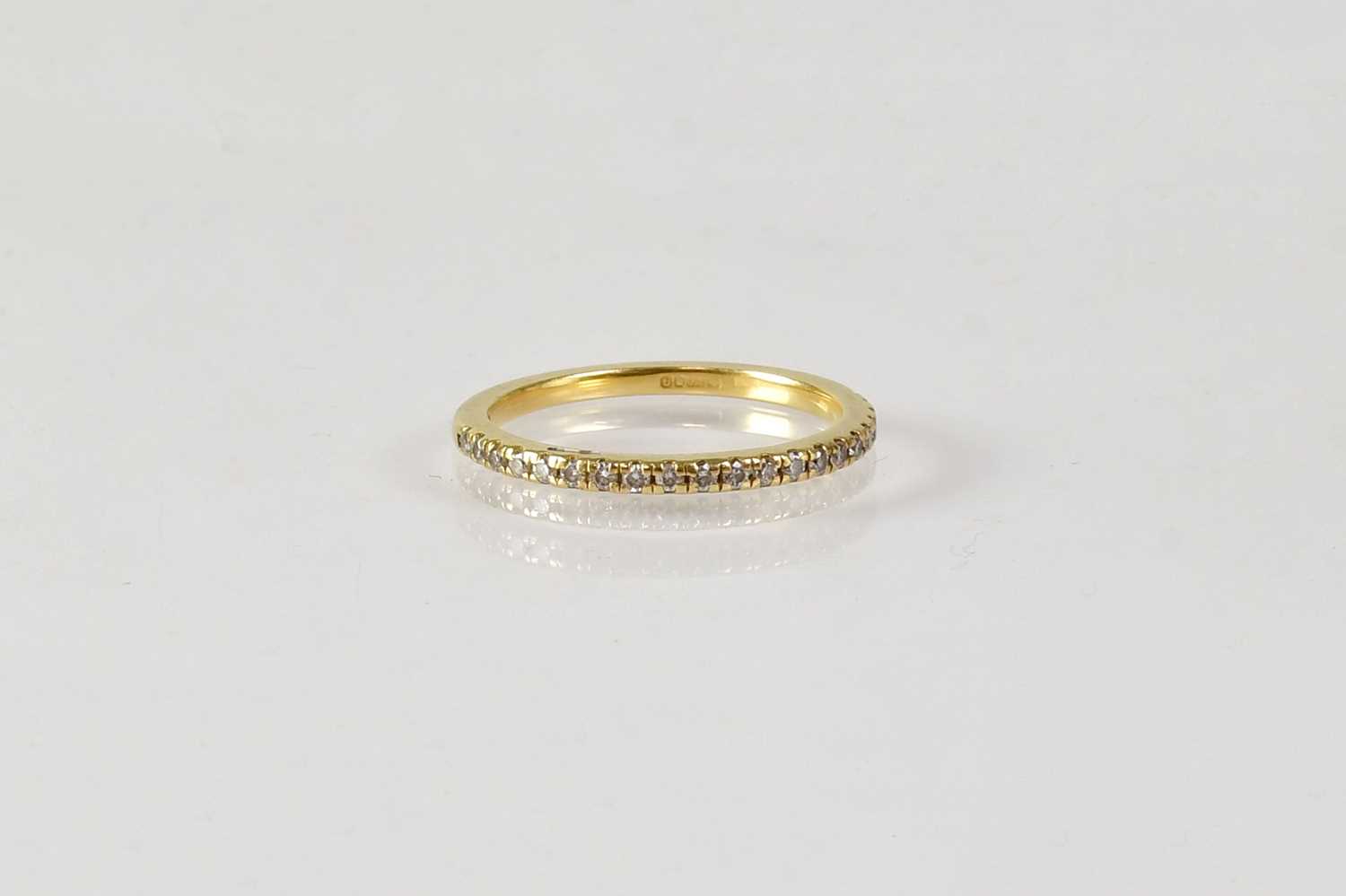 Lot 833 - An 18ct yellow gold half eternity ring set...