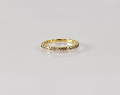 Lot 833 - An 18ct yellow gold half eternity ring set...